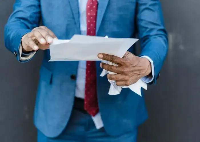 A man who is looking at HofsMedia SEO agency no contract policy and demolished the paper of our competition.